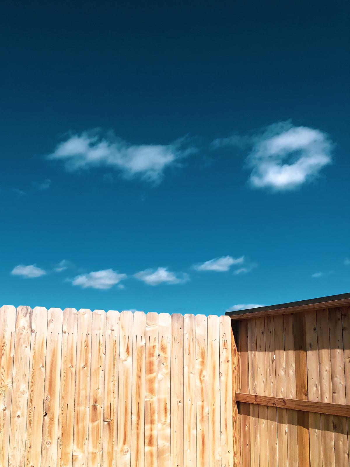 A group of people working on a fence installation project.