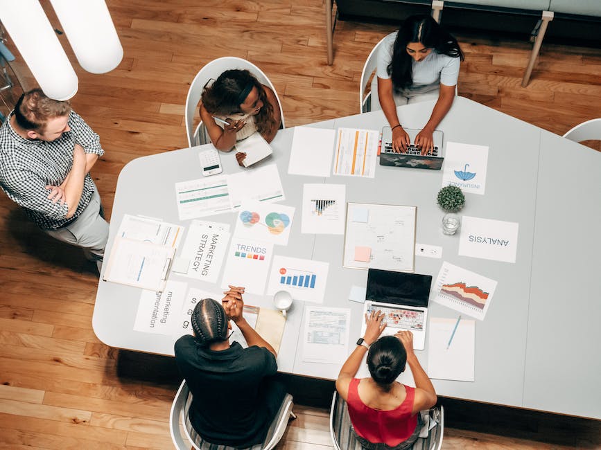 A group of people working together in an office, representing fence company marketing strategies.