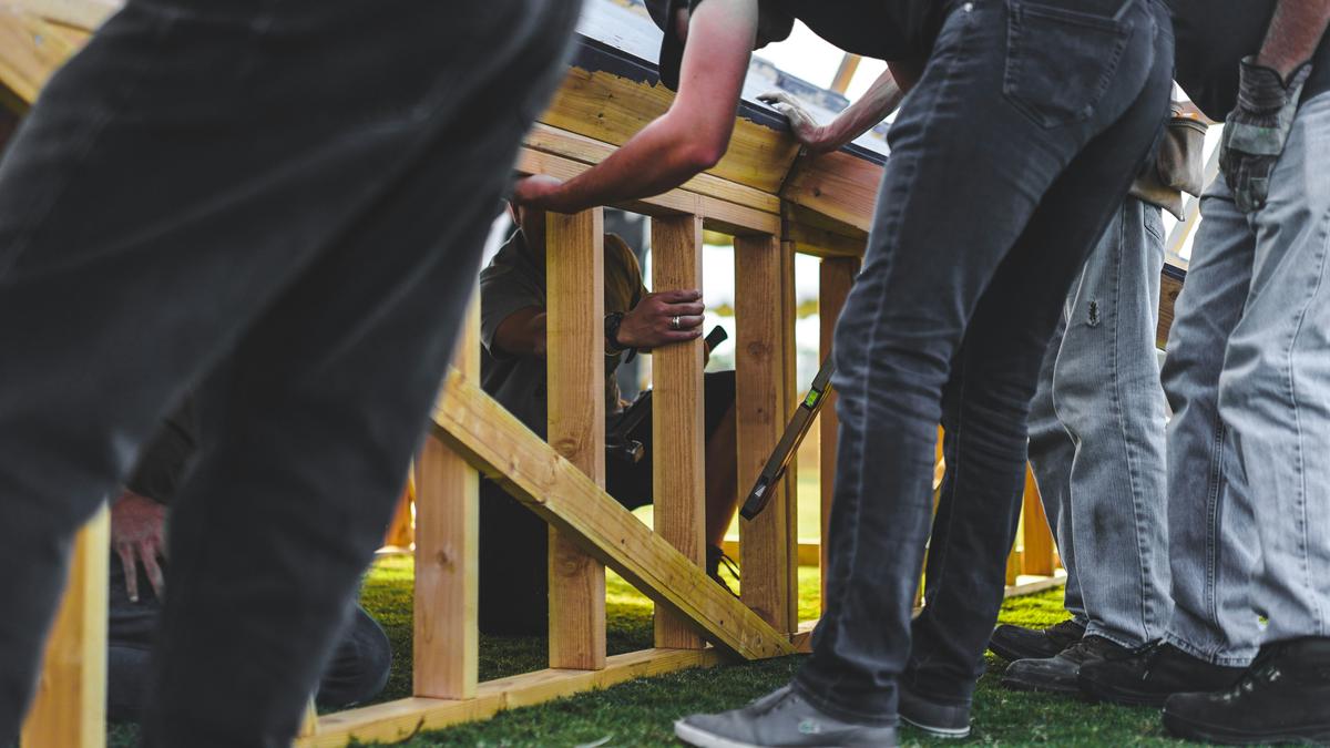 A construction worker building a fence with professionalism and expertise.